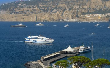 SORRENTO, ITALY - AUGUST 2019: Fast ferry arriving at the port of Sorrento. clipart