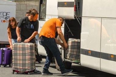 Napoli , İtalya - Ağustos 2019: Sorrento'da bir tur otobüsünün bagaj bölümüne bagaj yükleme.