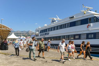 Sorrento, İtalya - Ağustos 2019: Hızlı feribotla geldikten sonra Sorrento limanında yürüyen insanlar.