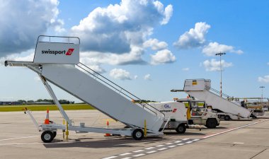 BRISTOL, ENGLAND - AUGUST 2019: Airport ground handling equipment operated by specialist contractor Swissport at Bristol Airport. clipart