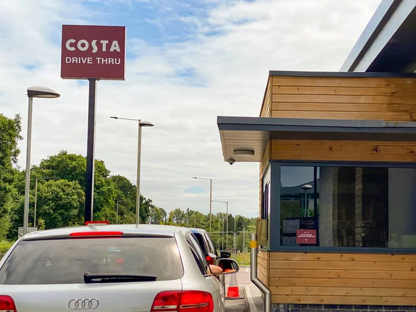 Talbot Green, Wales - Haziran 2020: Kosta Kahve dükkanının vitrininden siparişleri almak için bekleyen arabalar. Costa, şu anda Coca-Cola Company 'nin yan kuruluşu olan bir İngiliz kahve evi zinciri..