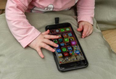 CARDIFF, WALES - MAYIS 2018: iPhone ile oynayan bir bebek