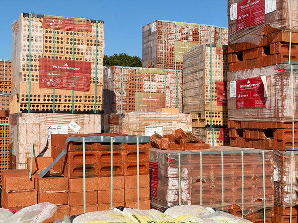 CARDIFF, WALES - SEPTEMBER 2020: Stacks of bricks and pallets of other materials in a builder's yard.