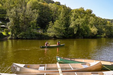 Symonds, Yat, England - September 2020:  Two people in a canoe on the River Wye in Symonds Yat. clipart