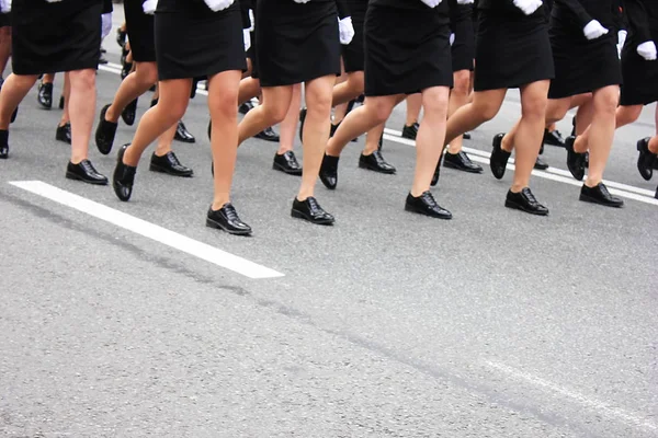 Womens legs marching. Women in the military parade.