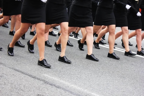 Womens legs marching. Women in the military parade.