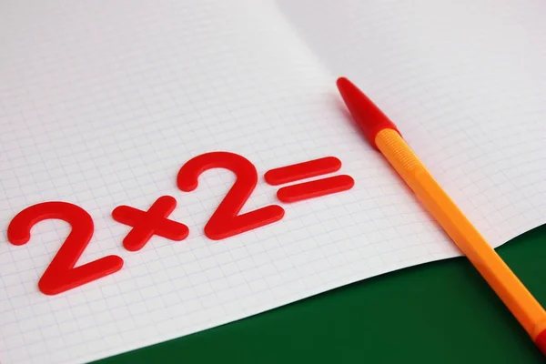 A simple mathematical example in a clean school notebook. Back to school. — Stock Photo, Image