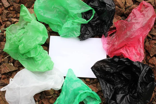 A bunch of reusable, multi-colored plastic bags polluting the environment.