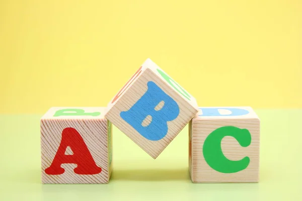 ABC -the first letters of the English alphabet on wooden toy cubes.