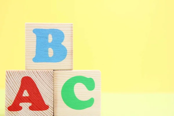 ABC -the first letters of the English alphabet on wooden toy cubes.