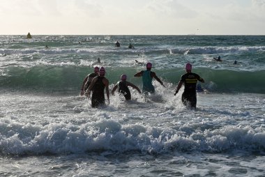 Kadın triatletler 2019 South Beach Triatlon başında sörf girin.