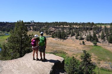 Young couple on Misery Ridge Trail in Smith Rock State Park, Oregon. clipart