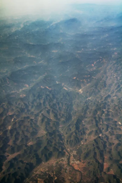 Aerial view of earth with mountains and forest