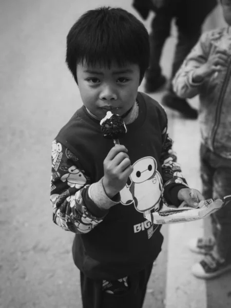 Black and white photo of asian little boy