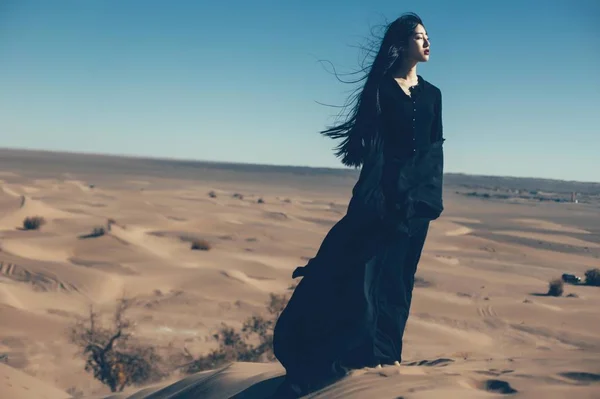 Asian woman posing in desert