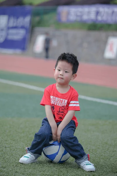 Asian small boy playing football