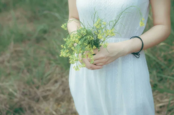 pregnant bride holding bouquet of flowers