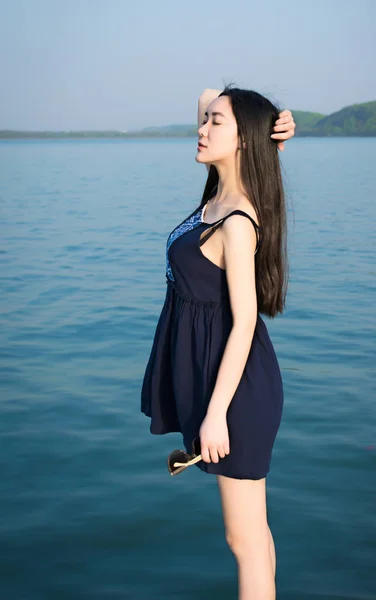 Stylish asian girl on the sea