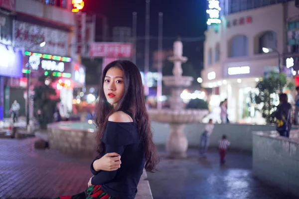 Young asian woman at night street