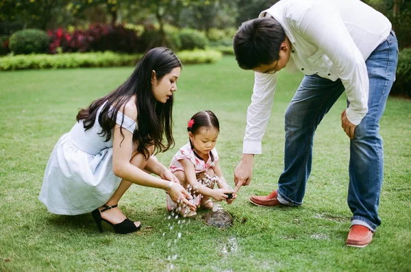 Asian parents with daughter in park