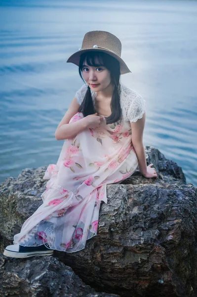 Asian woman posing near sea
