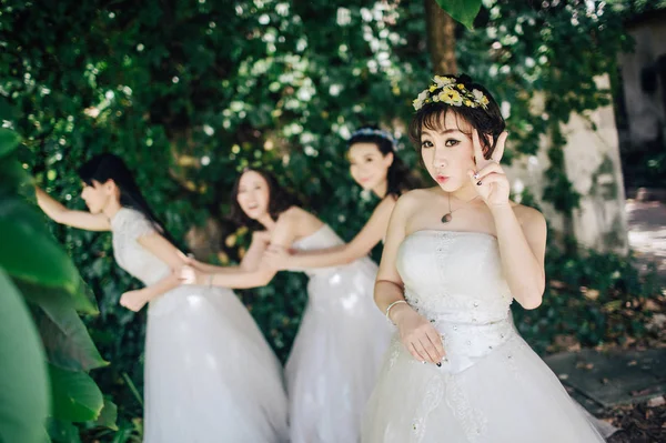 Young bride with her friends  in park