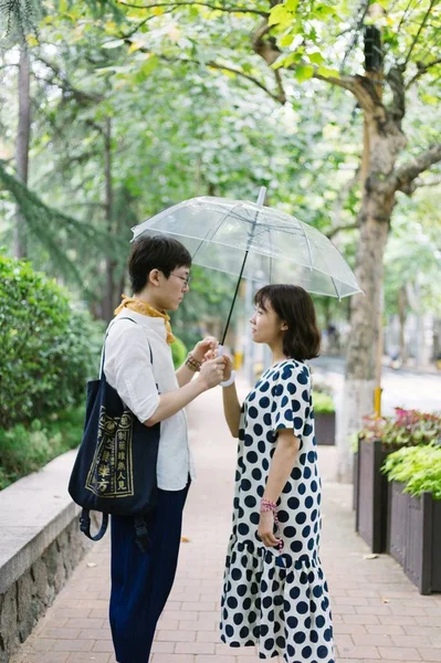 Young asian couple walking in city