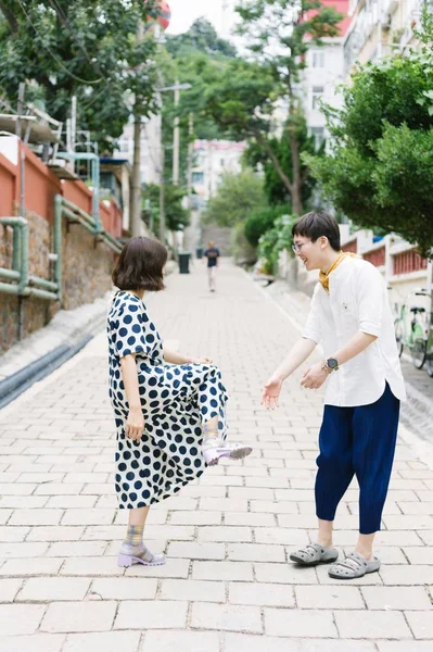 Young asian couple walking in city