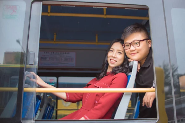 asian couple sitting in bus