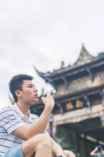 handsome Asian man posing at Chengdu city