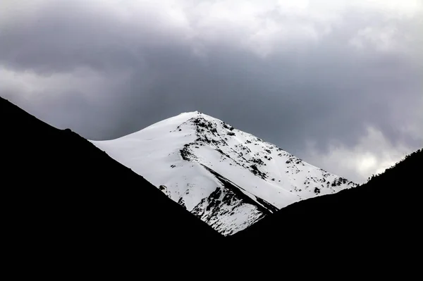 black mountain landscape with snow.