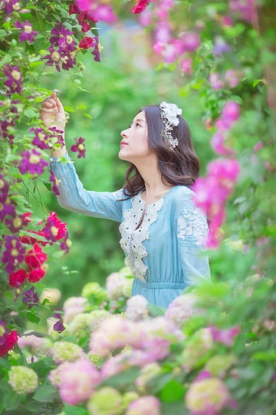 asian woman posing with flowers blossoming