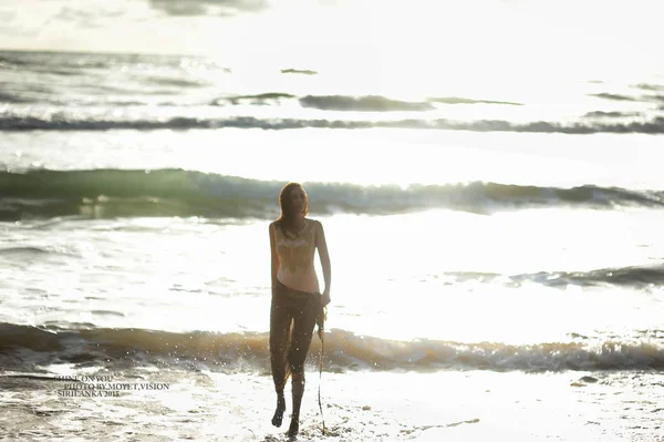 Young woman walking in sea