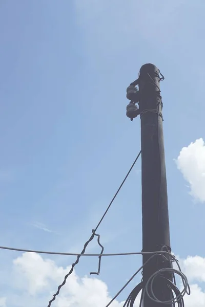 old telephone tower against blue sky