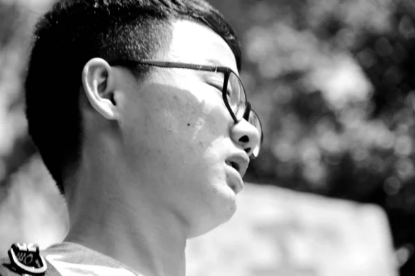 black and white portrait of young asian man at daytime