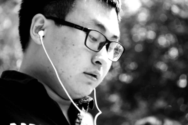 black and white portrait of young asian man at daytime