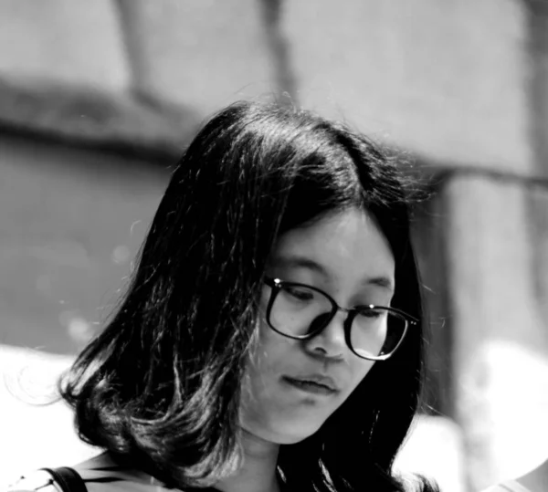 black and white portrait of young asian woman at daytime