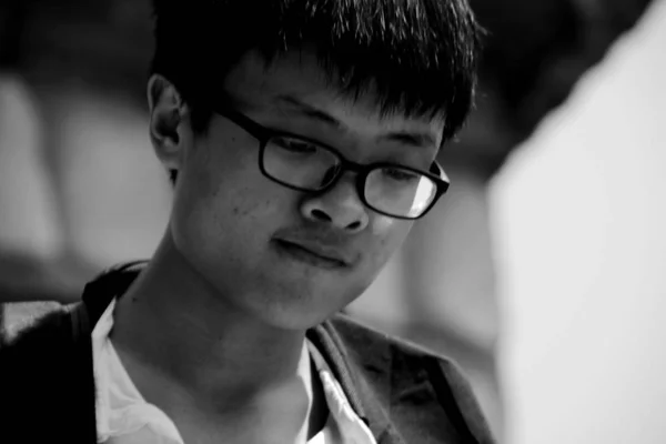 black and white portrait of young asian man at daytime