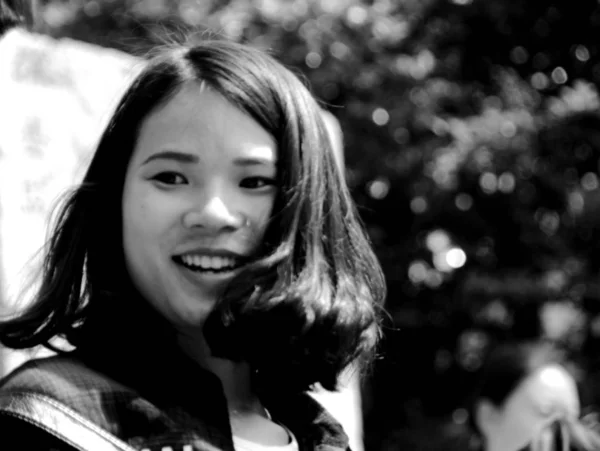 black and white portrait of young asian woman at daytime