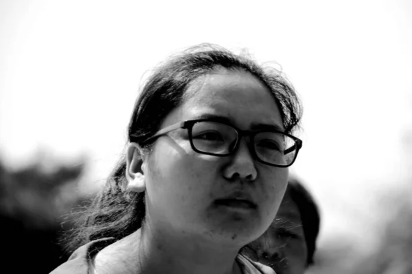 black and white portrait of young asian woman at daytime