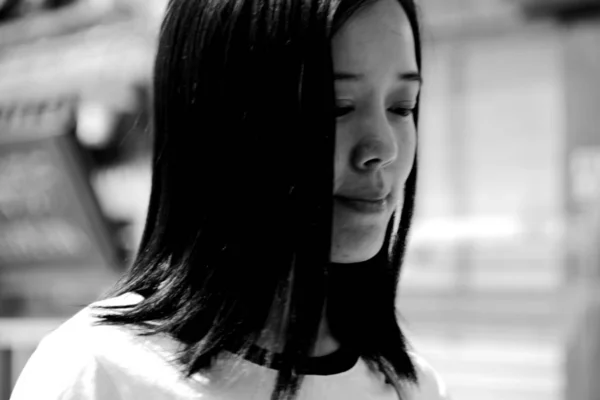 black and white portrait of young asian woman at daytime