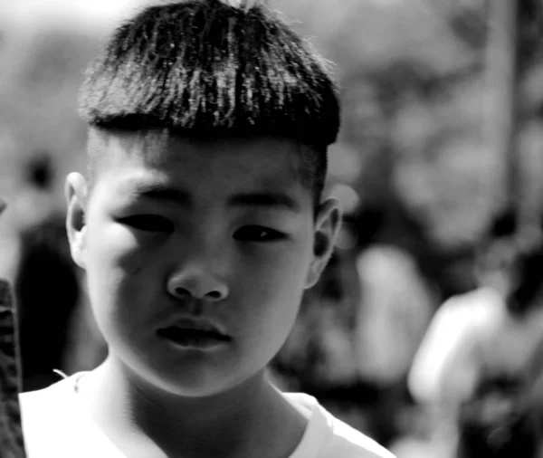 black and white portrait of asian boy at daytime