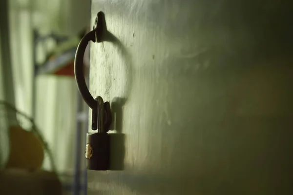close up of a metal door handle with a lock