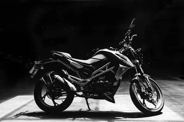 black and white motorcycle on a dark background