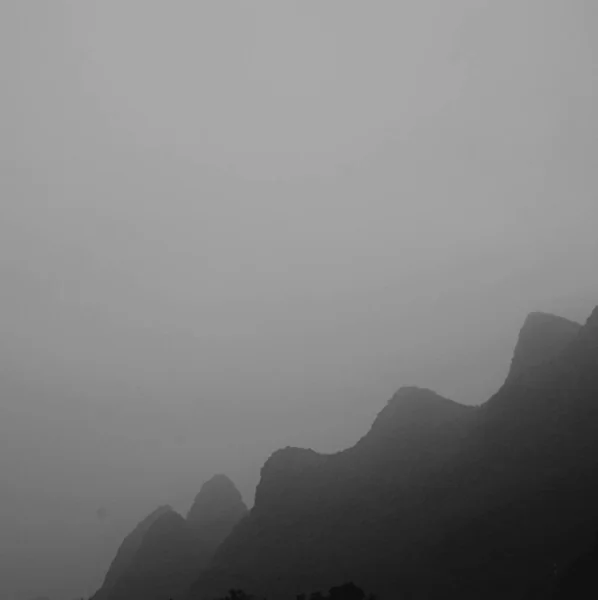 black and white background with mountains