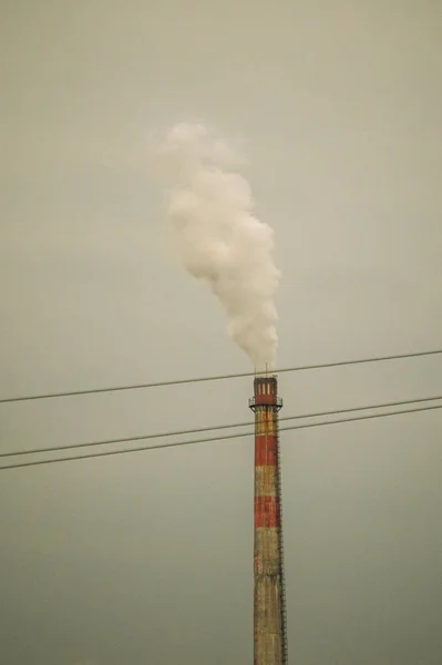 industrial pipes and smoke from factory