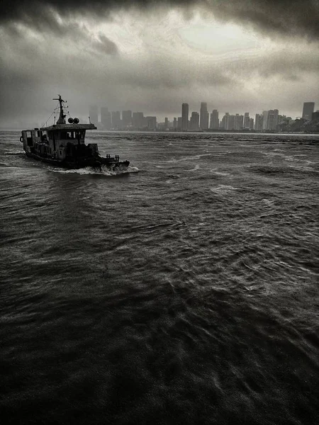 black and white photo of a ship in the sea