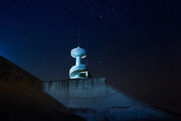 lighthouse in the night sky