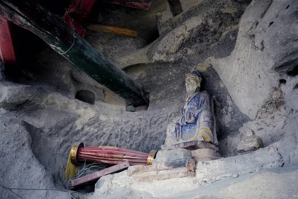 a man in a cave in a buddhist temple