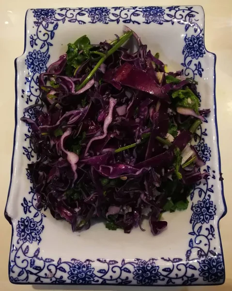 salad with red cabbage and green leaves